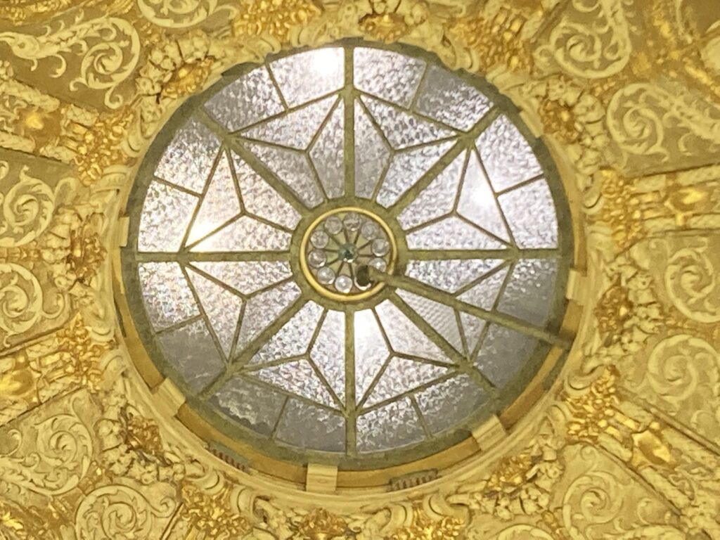 Beautiful vintage crystal pattern glass ceiling with golden carved patterns on the side