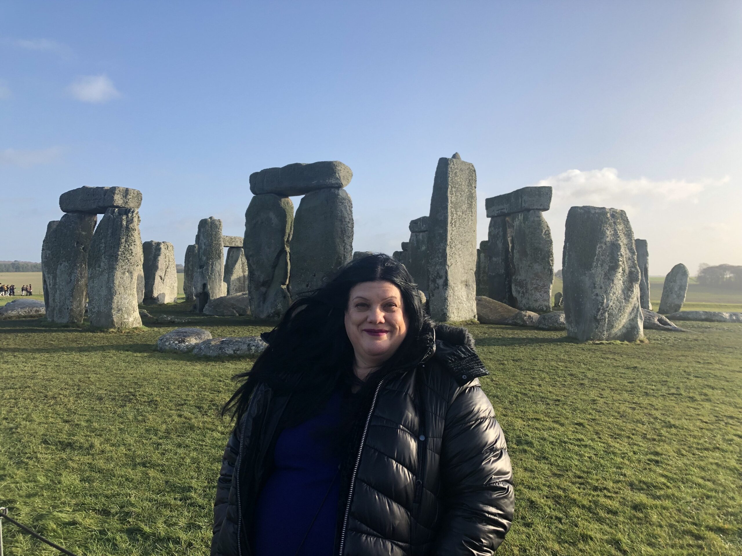 Woman standing in front of the Stonehenge Stone Circle 