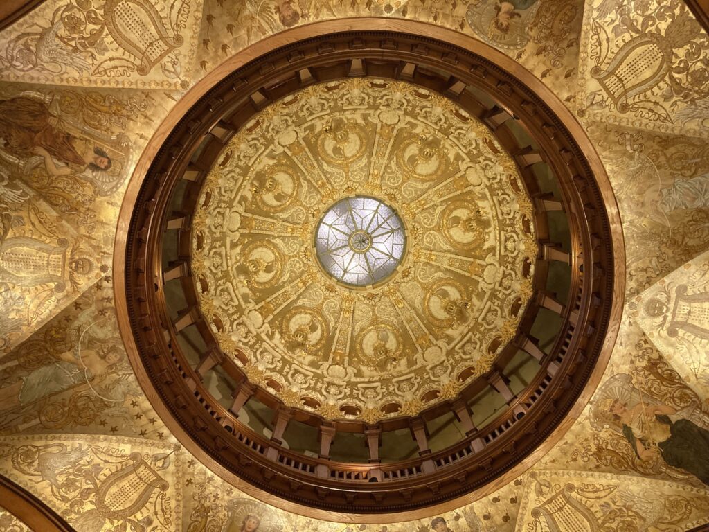 Vintage glass ceiling in a gold carved patterns with wood accent around it