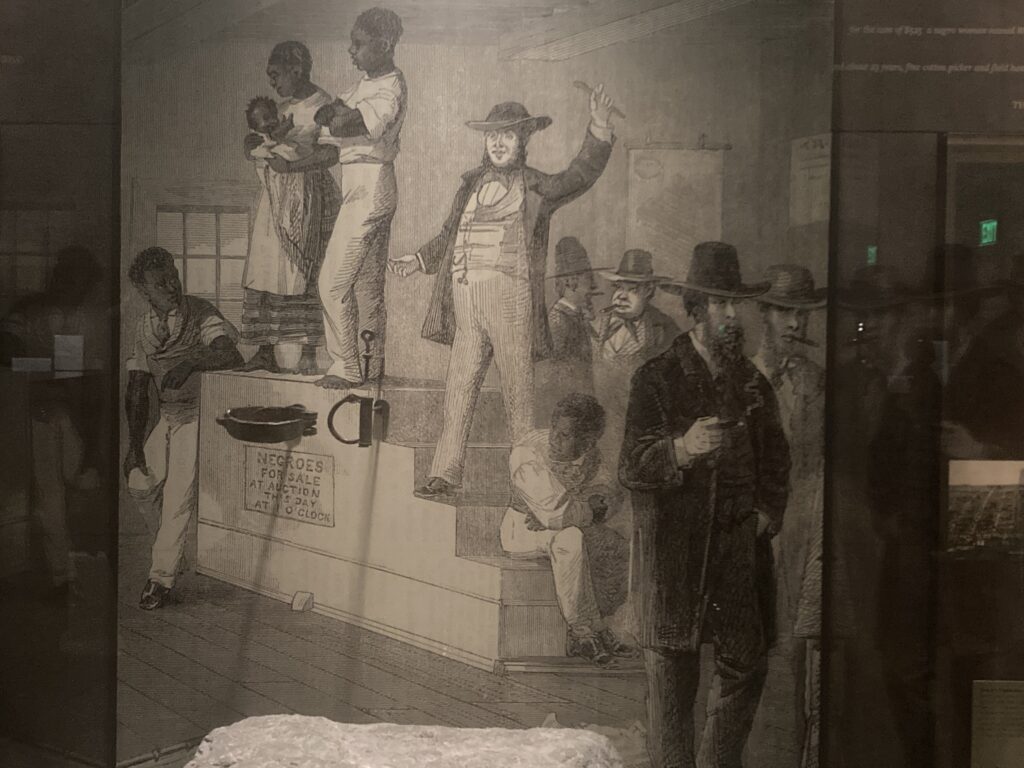 Slave mothers and babies on an auction block