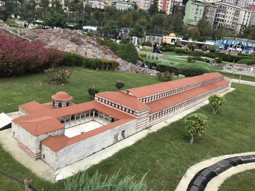 Orange Roof Brick Building Miniature in the Ground