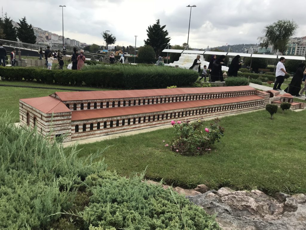 Long Rectangular Orange Brick Building Miniature in the Ground