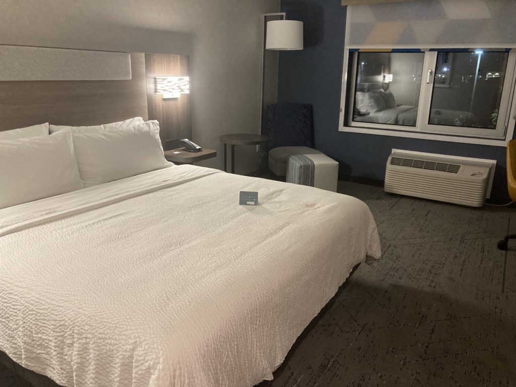 Inside the Hotel Room with Queen Size White Bed