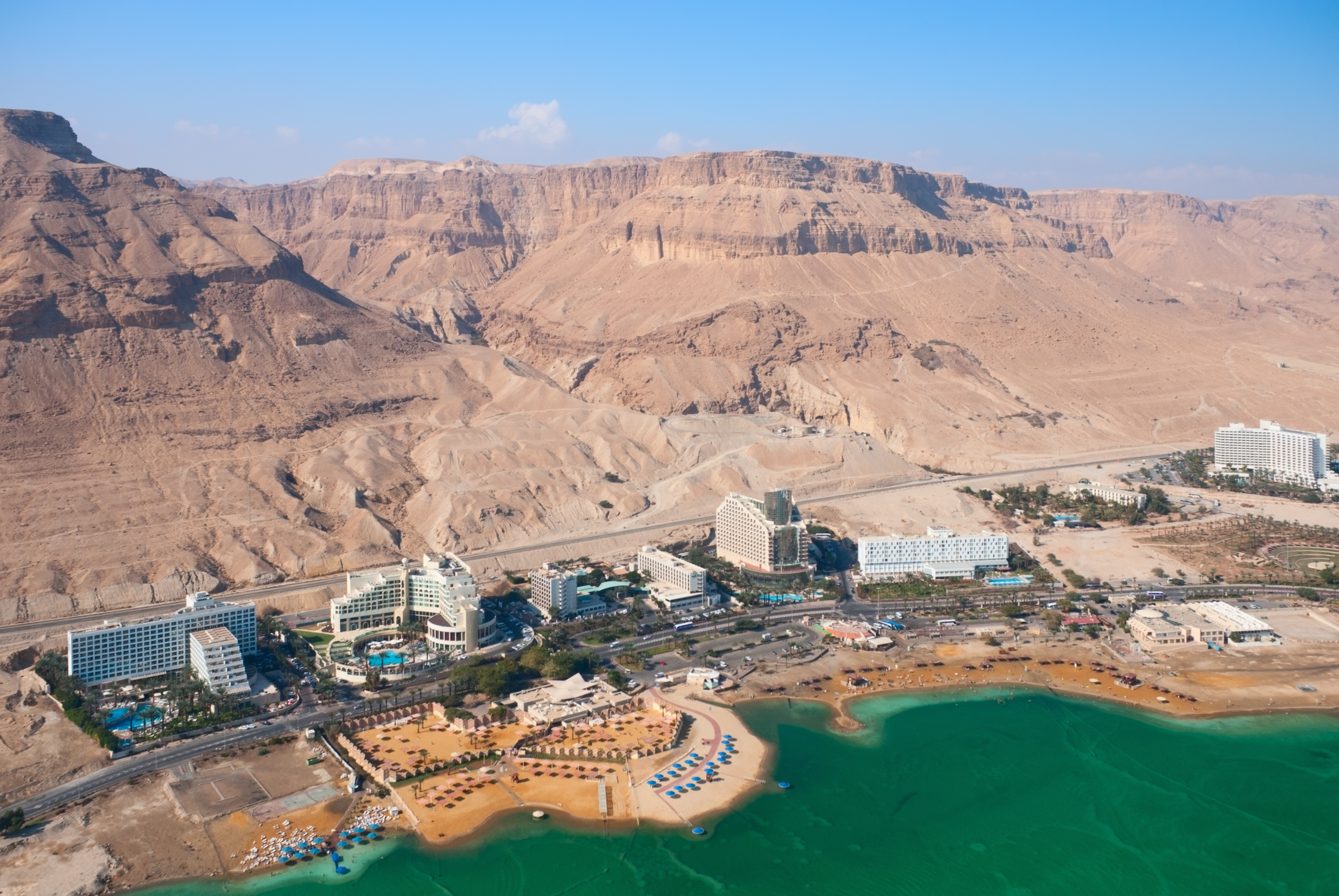 Overhead picture of Dead Sea Hotels in Israel with Dead Sea in front and mountains in back