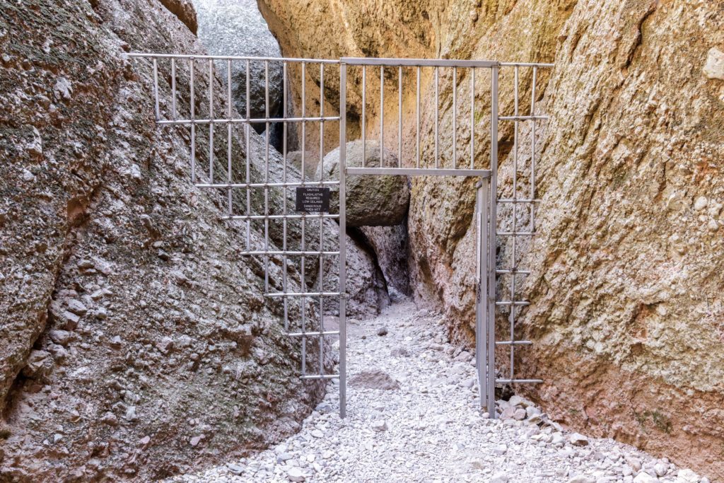 Metal Gate in Between Big Rocks