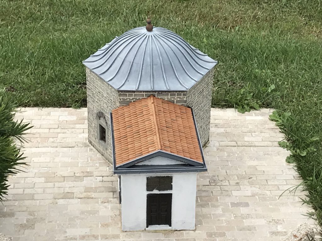 Blue and Orange Roof Building Miniature in the Ground